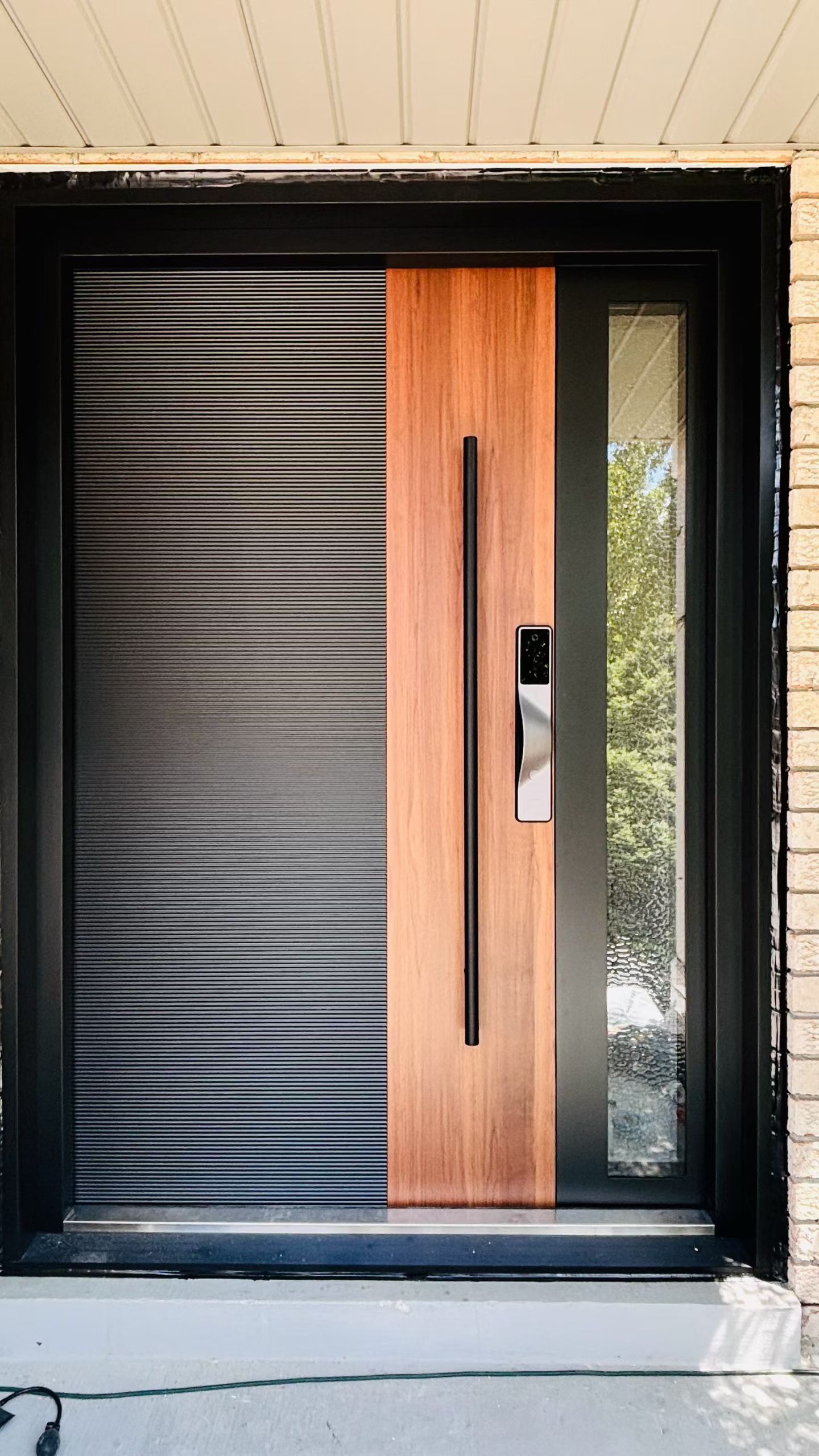 Wood-look entrance door with a glazed sidelight.