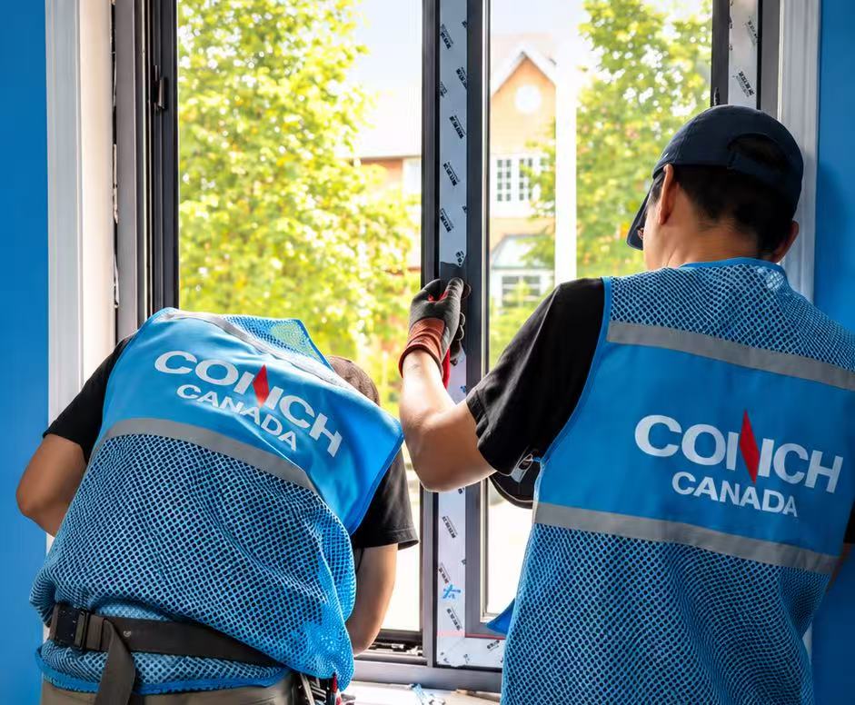 Conch Canada installers working on an interior window