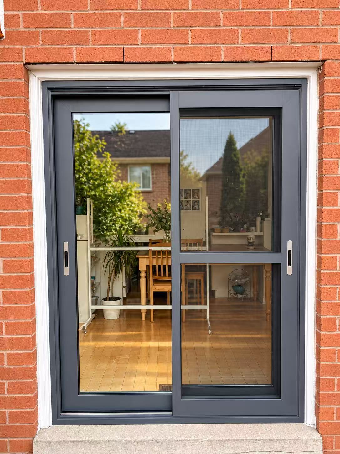 Dark-framed sliding patio doors viewed from outside.
